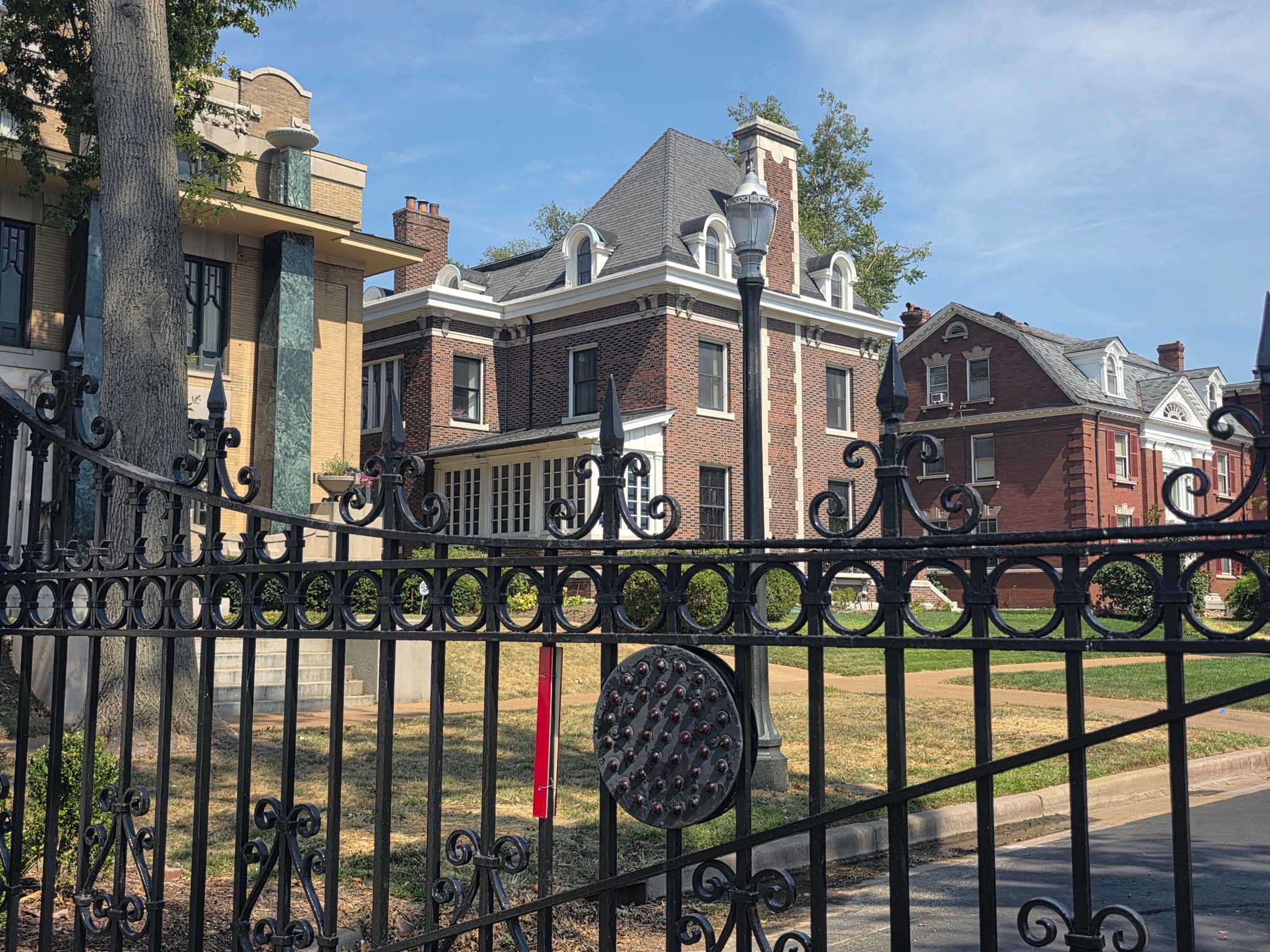 Gilded Age mansions on Portland Place in the Central West End, St. Louis — a gated private street with limestone-clad homes and mature trees